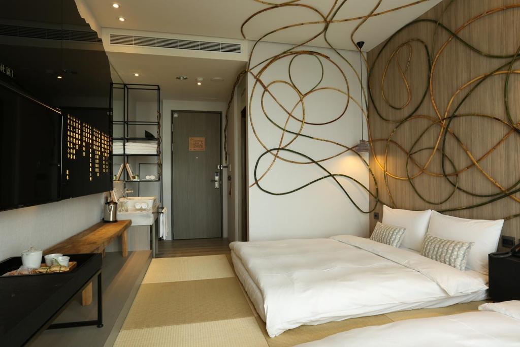 Ein Bett oder Betten in einem Zimmer der Unterkunft Hotel Day Plus Teascape