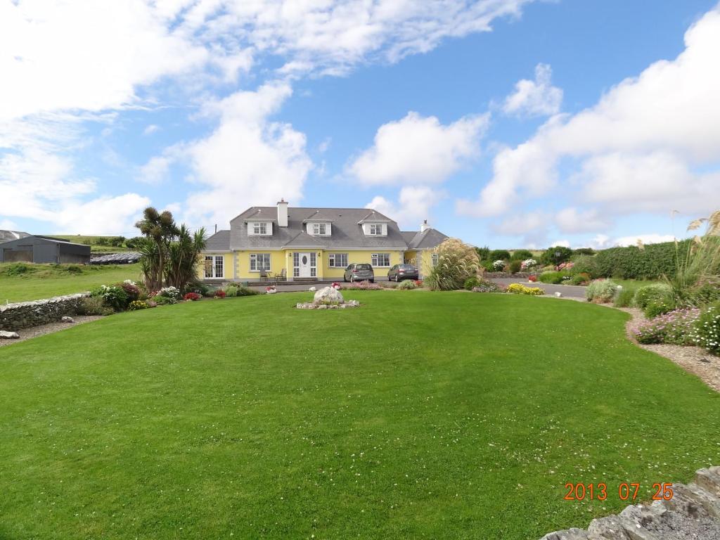 a large lawn in front of a house at Atlantic View B&B in Liscannor