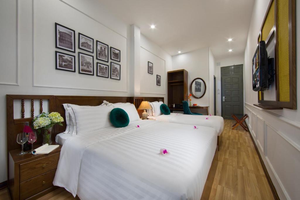 Postel nebo postele na pokoji v ubytování Hanoi Amber Hotel