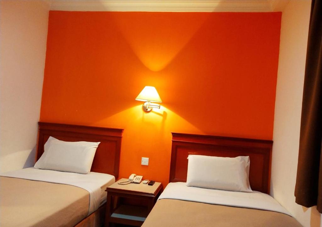 Postel nebo postele na pokoji v ubytování Megah Inn