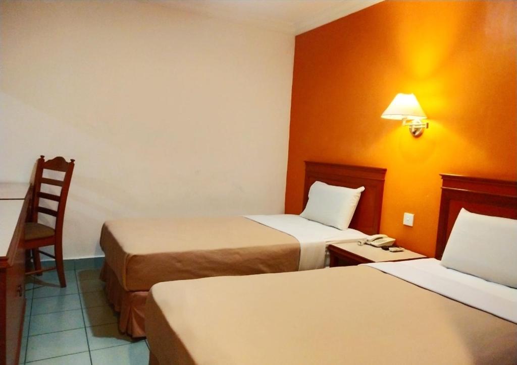 Postel nebo postele na pokoji v ubytování Megah Inn