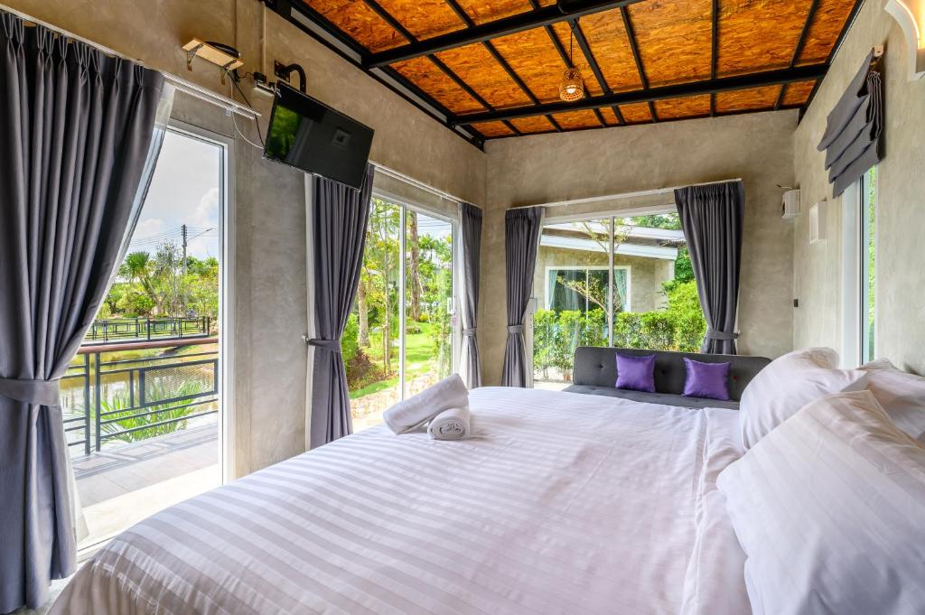 Postel nebo postele na pokoji v ubytování Loftpical Resort