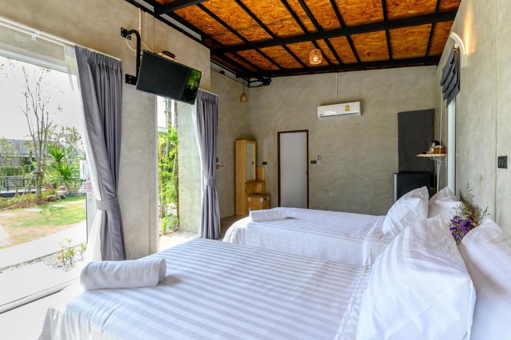 Postel nebo postele na pokoji v ubytování Loftpical Resort