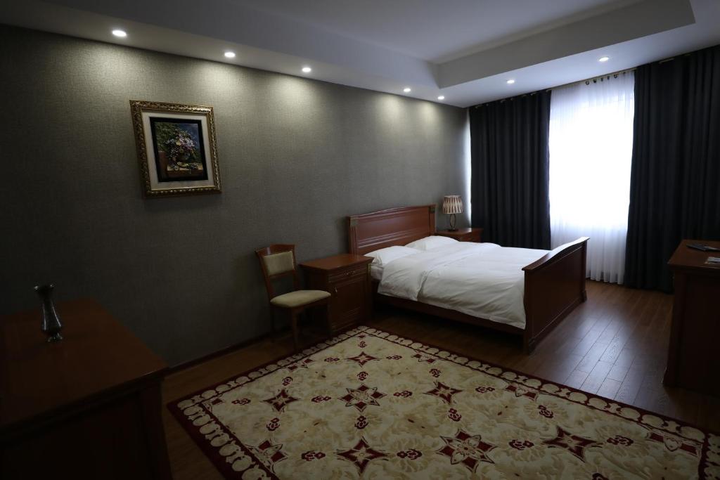Postel nebo postele na pokoji v ubytování Bokhtar Apart Hotel