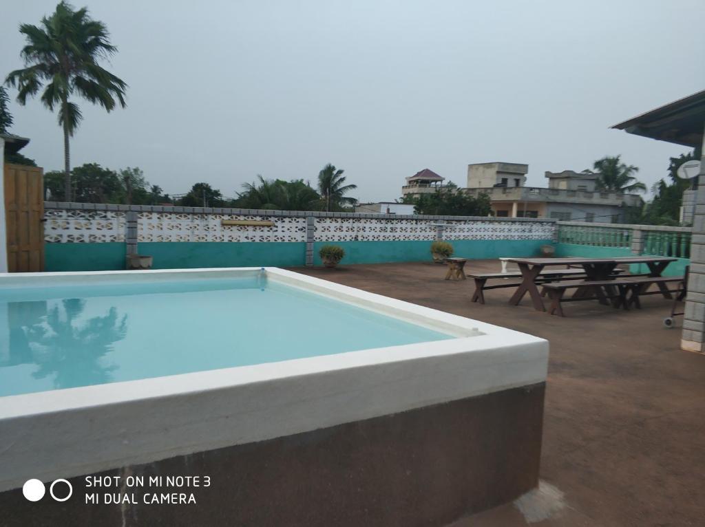 a large swimming pool on the roof of a house at Bougainvilliers in Afanbo