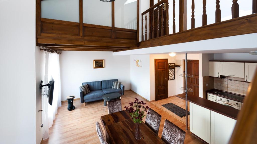 a living room with a couch and a table at Apartamenty Sun & Snow Centrum in Zakopane