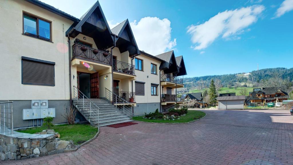 a building with a staircase on the side of it at Apartamenty Sun & Snow Centrum in Zakopane