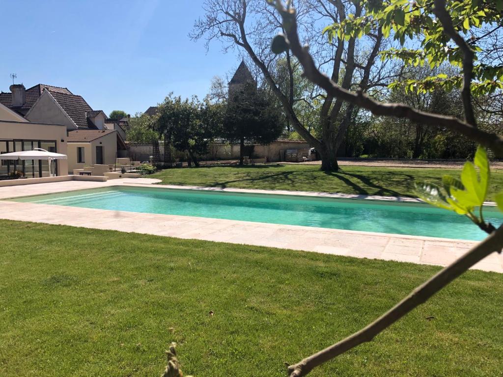 uma piscina no quintal de uma casa em Demeure Larmandier em Les Mesneux