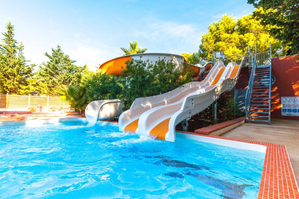 a water slide in a swimming pool at Camping La Croix du Sud in Le Barcarès