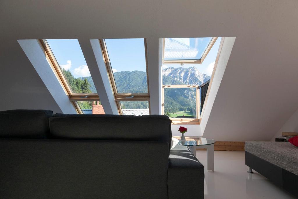 a living room with a couch and large windows at Apartments Julian Experience in Rateče