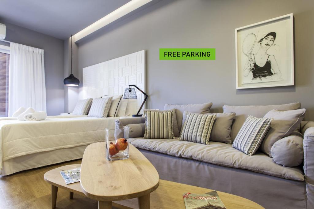 a living room with a couch and a bed at Candia Studios & Rooms in Heraklio Town