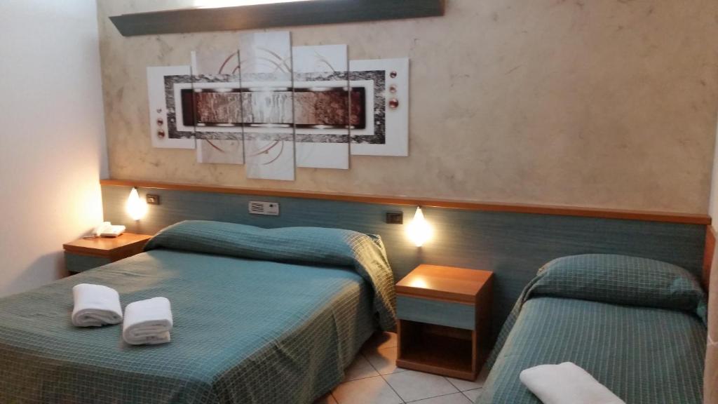 Postel nebo postele na pokoji v ubytování Albergo Al Cacciatore