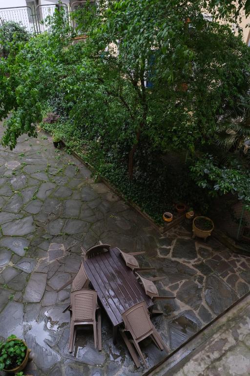 a wooden bench and chairs on a patio at B&B Kingsman in Florence