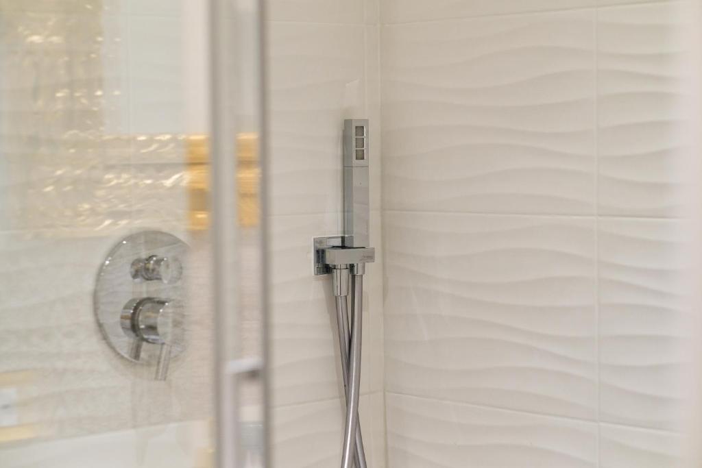 a shower with a shower head in a bathroom at B&B Kingsman in Florence