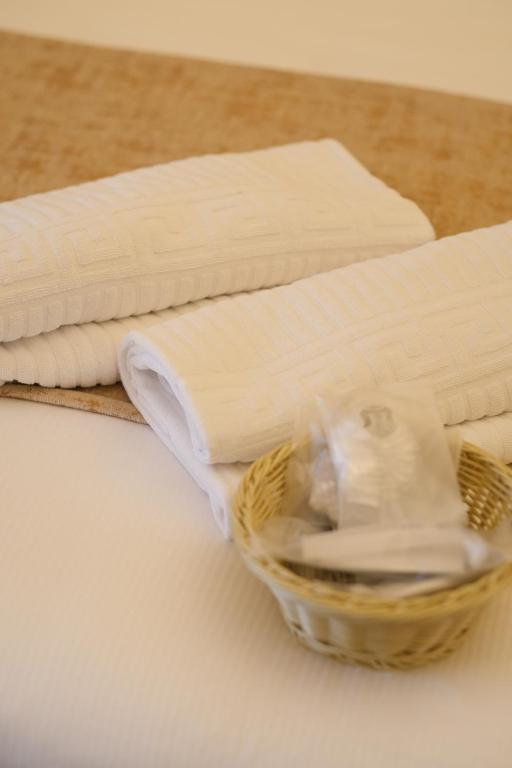 a basket filled with white towels on a table at B&B Kingsman in Florence