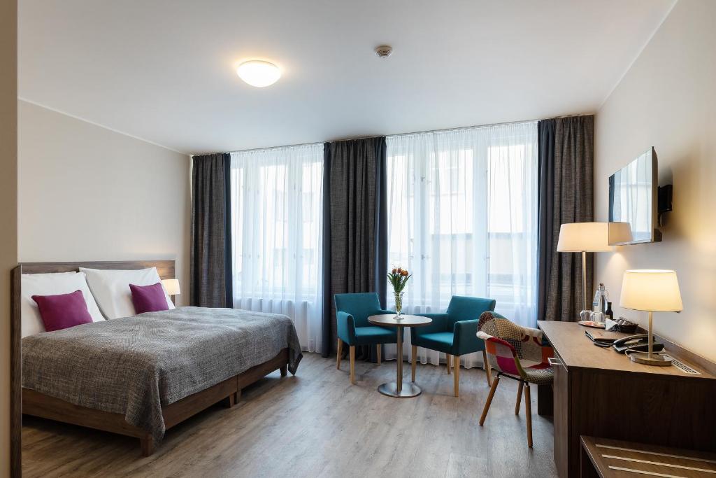 Łóżko lub łóżka w pokoju w obiekcie Hotel Melantrich