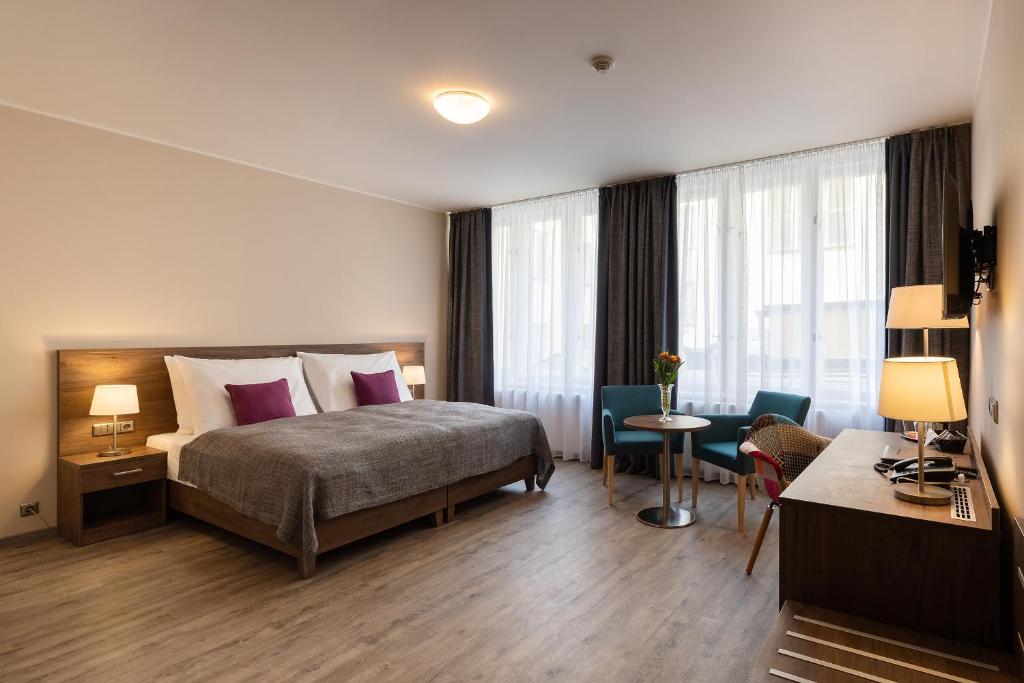 Łóżko lub łóżka w pokoju w obiekcie Hotel Melantrich