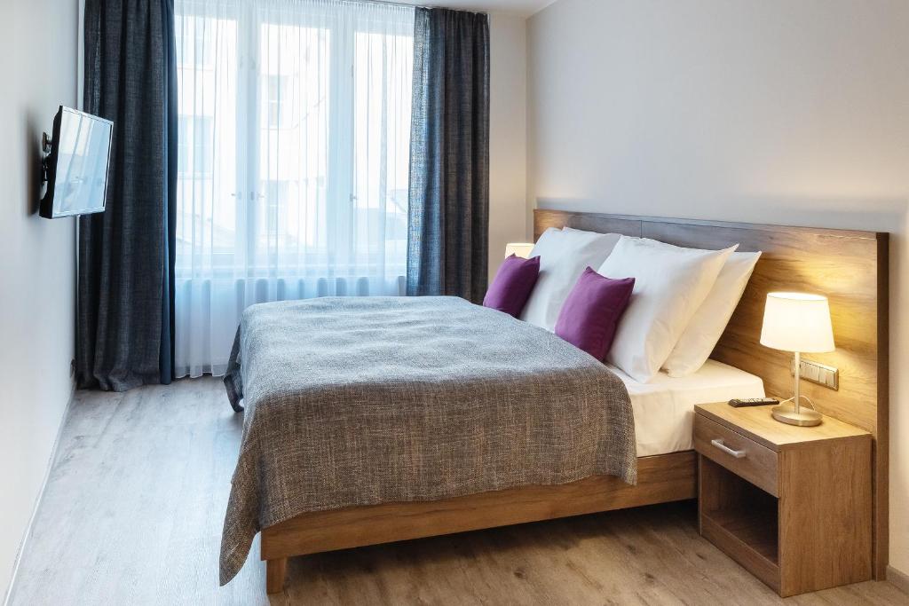 Łóżko lub łóżka w pokoju w obiekcie Hotel Melantrich