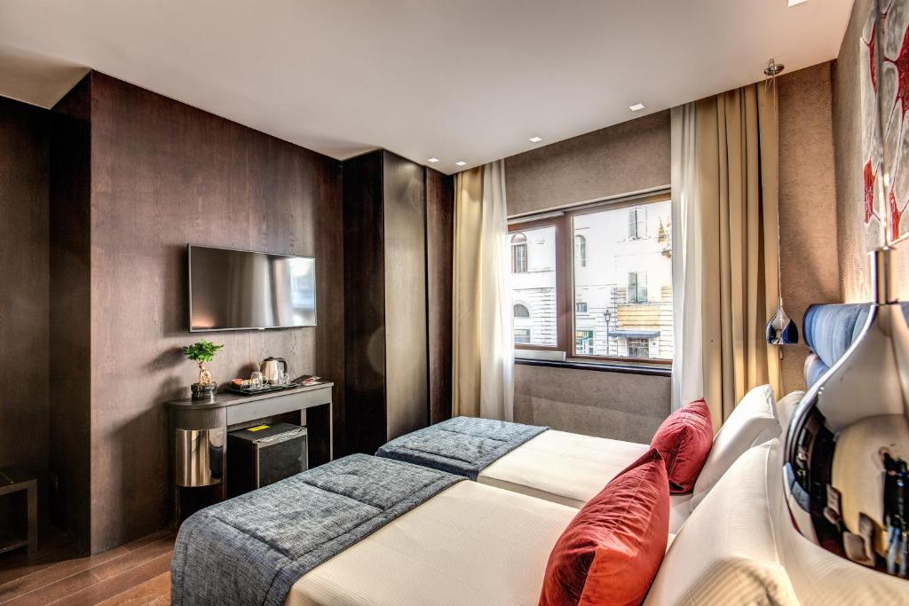 Postel nebo postele na pokoji v ubytování Prassede Palace Hotel