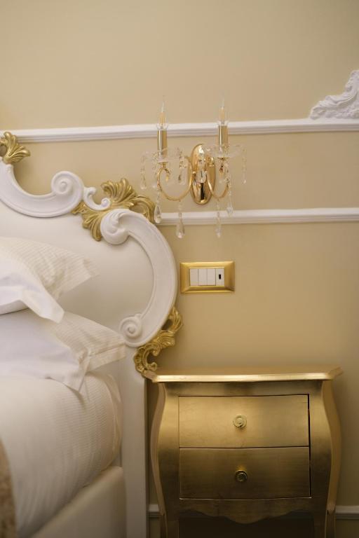 a bedroom with a bed and a side table with a lamp at B&B Kingsman in Florence