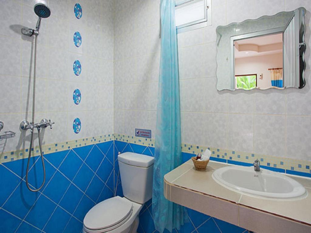 a blue and white bathroom with a toilet and a sink at Grand View in Patong Beach