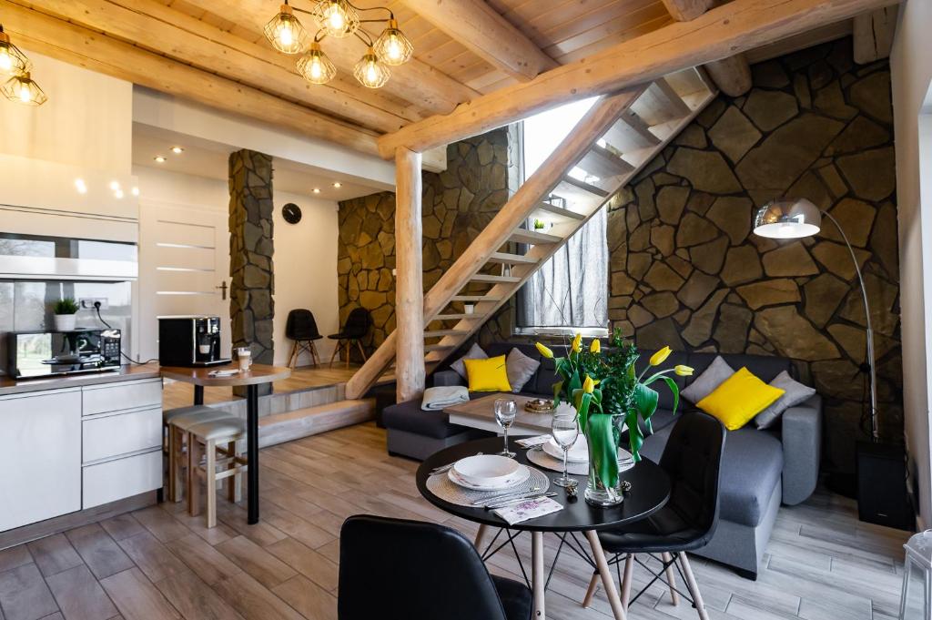 a kitchen and living room with a stone wall at Apartament Podmagura in Szczyrk