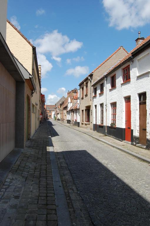 an empty street in a town with buildings at B&B 't Walleke in Bruges