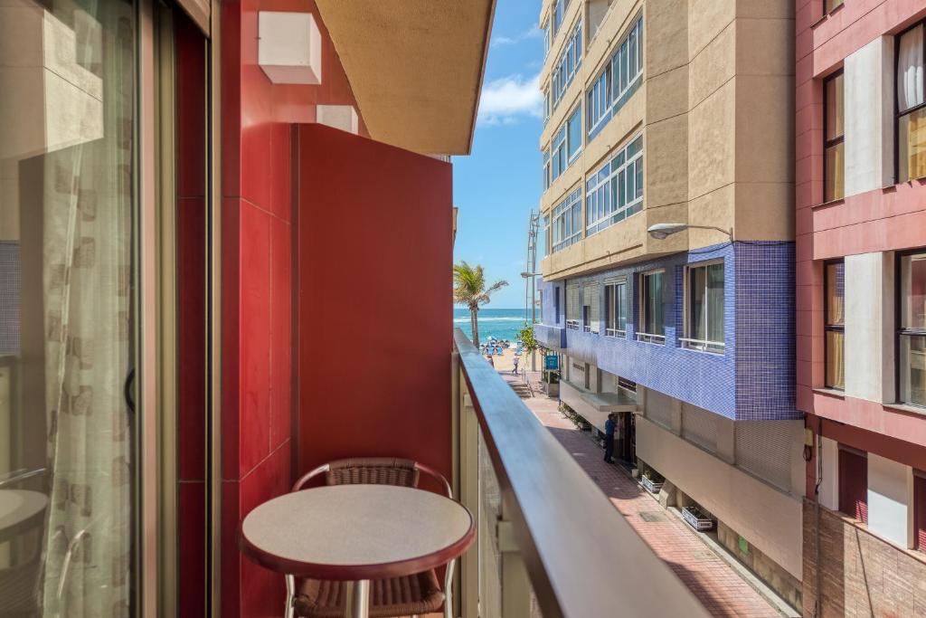 a balcony with a table and a view of the ocean at RK Atlantis Vacational in Las Palmas de Gran Canaria