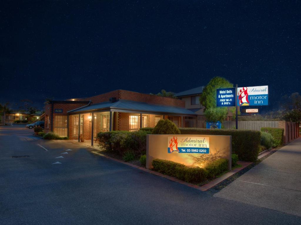 a building with a sign on the side of a street at Admiral Motor Inn in Rosebud