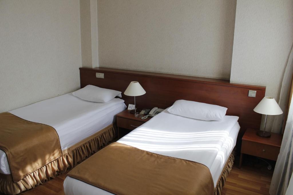 Postel nebo postele na pokoji v ubytování Saban Acikgoz Hotel