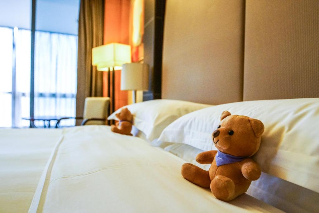Postel nebo postele na pokoji v ubytování Hyatt Regency Dongguan