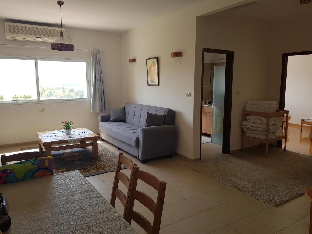 a living room with a couch and a table at Bertha's Coffee in El ‘Affūle