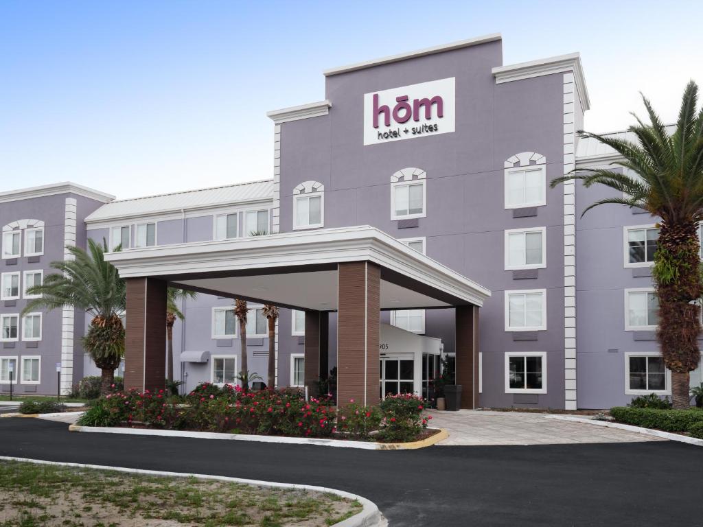 a hotel building with a h inn sign on it at HoM, A Trademark Collection Hotel in Gainesville