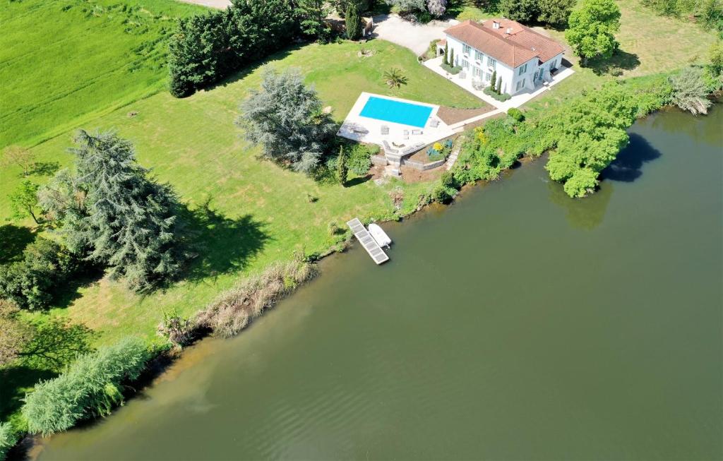 an aerial view of a house on an island in the water at Domaine du Beau Rivage in Le Temple-sur-Lot