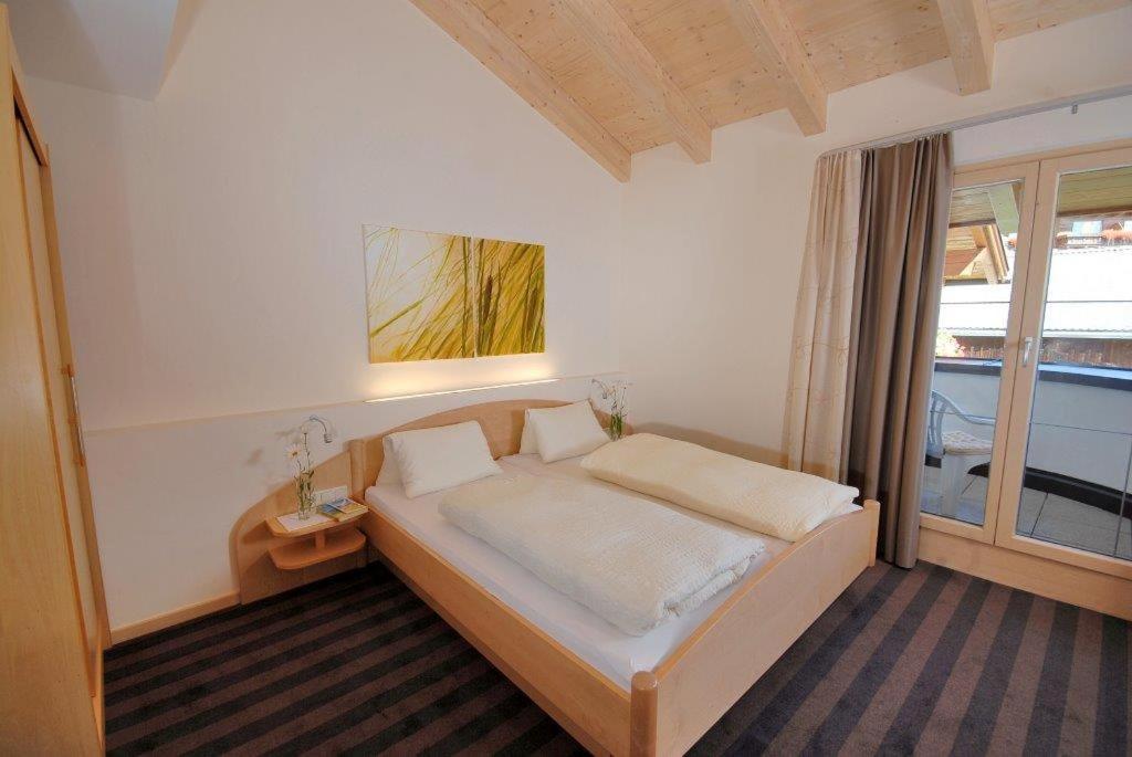 Postel nebo postele na pokoji v ubytování Apart Hotel Garni Kofler