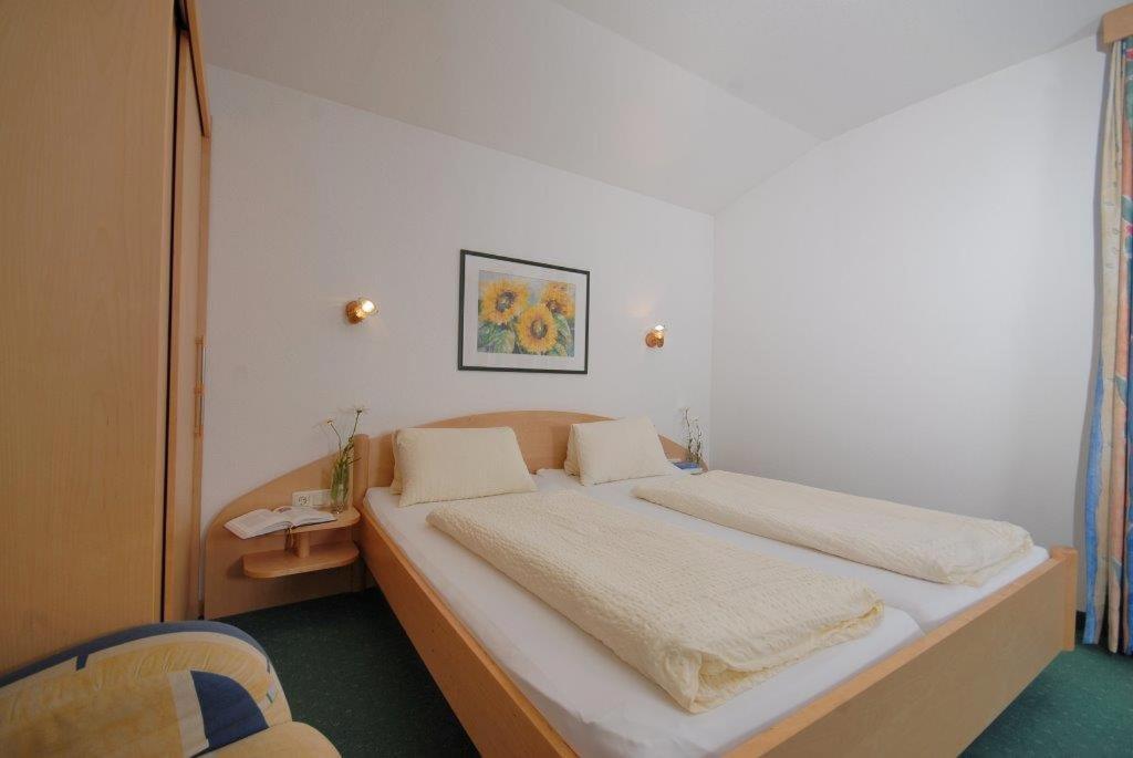 Postel nebo postele na pokoji v ubytování Apart Hotel Garni Kofler