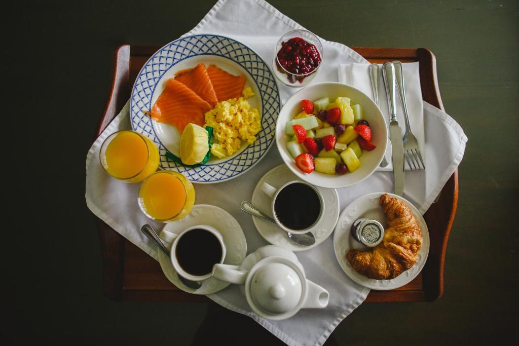 a table with plates of breakfast food and cups of coffee at Bushmills Inn Hotel & Restaurant in Bushmills