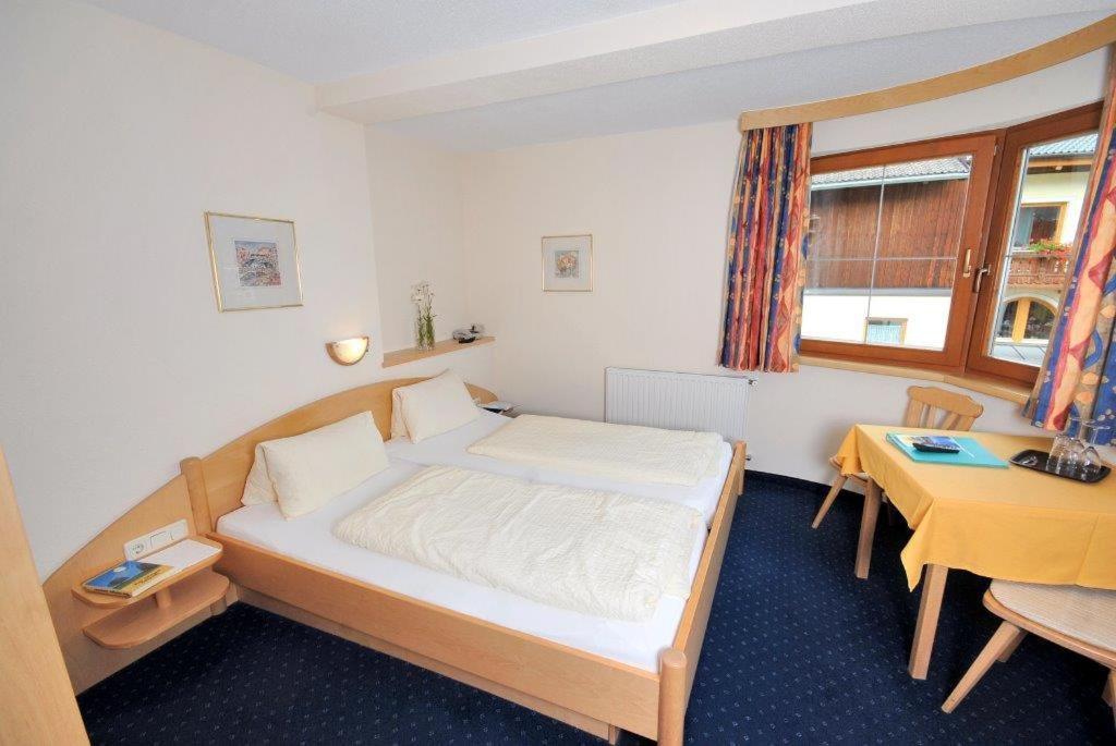 Postel nebo postele na pokoji v ubytování Apart Hotel Garni Kofler