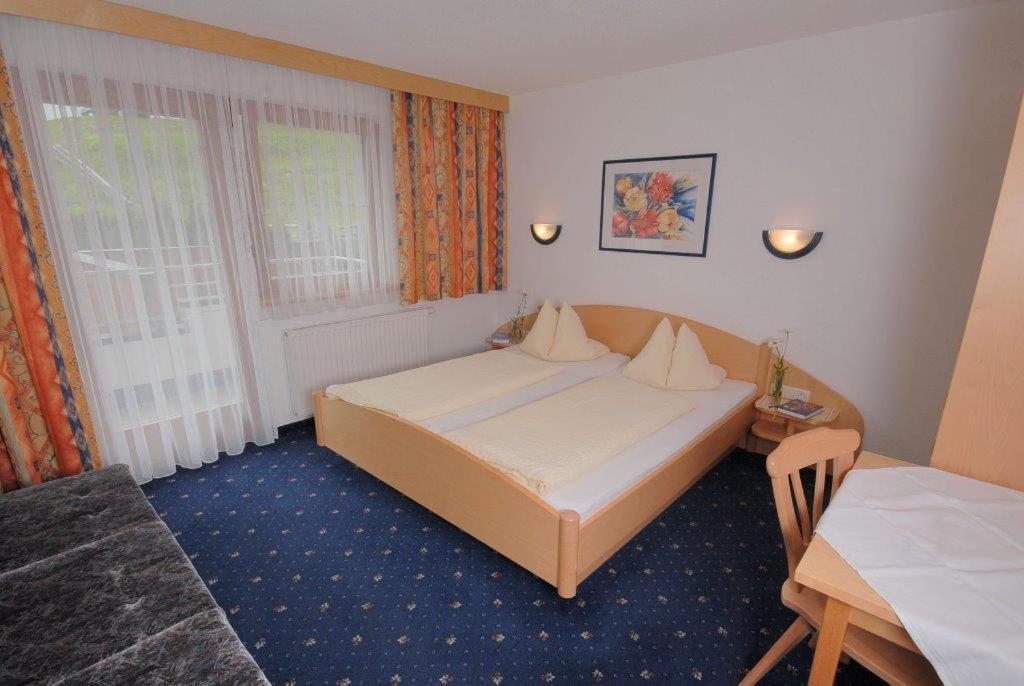 Postel nebo postele na pokoji v ubytování Apart Hotel Garni Kofler