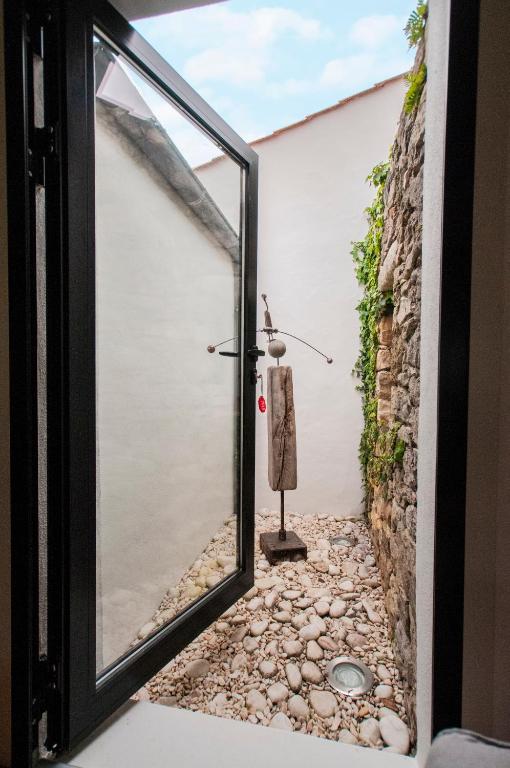 a room with a window and a stone wall at Les Yeux Bleus Bed &amp; Breakfast in Noirmoutier-en-l&#39;lle