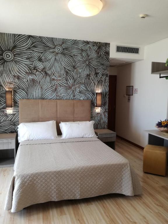 Postel nebo postele na pokoji v ubytování Hotel Excelsior