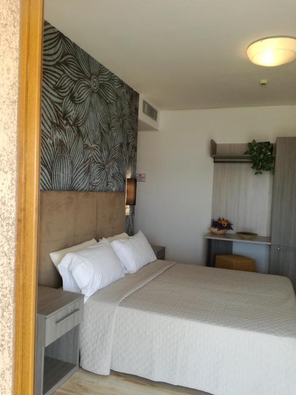 Postel nebo postele na pokoji v ubytování Hotel Excelsior