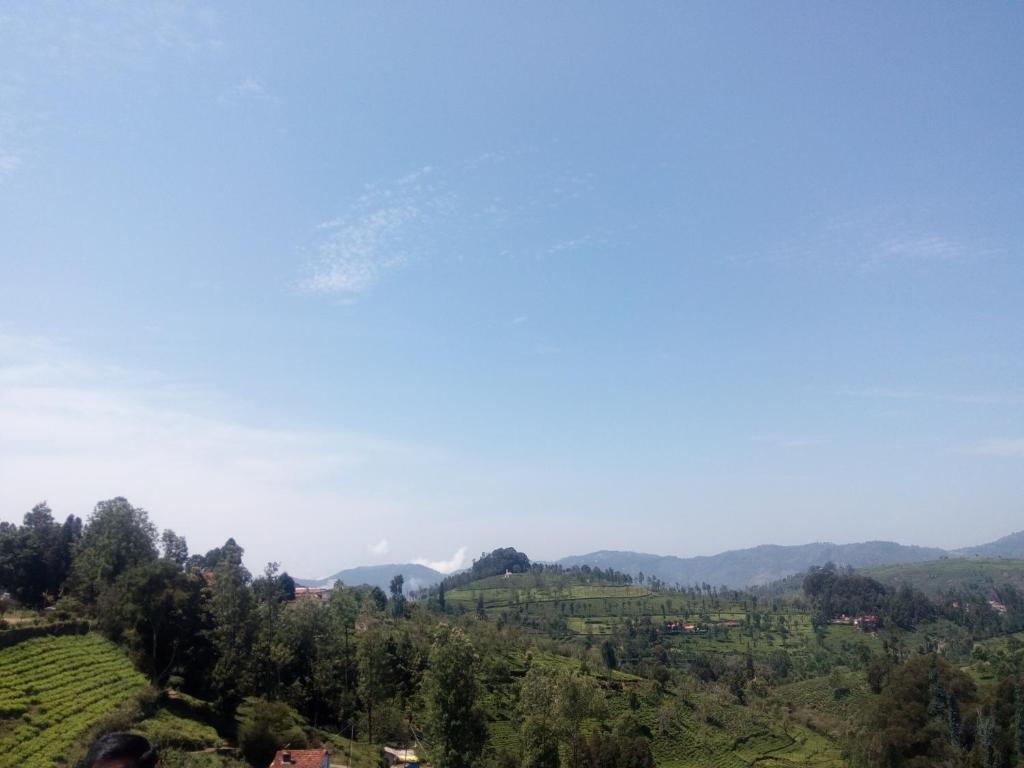 a view of a valley with mountains and trees at Dream Nest Resorts in Kotagiri