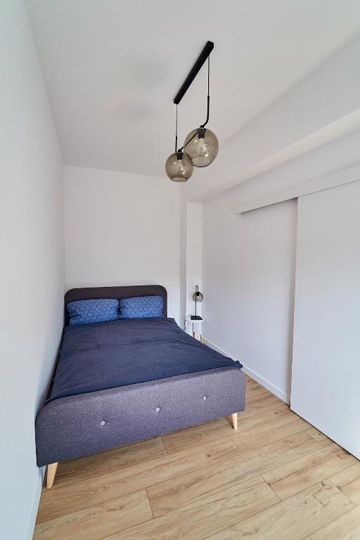 Posteľ alebo postele v izbe v ubytovaní Apartamenty Muzyczna 14