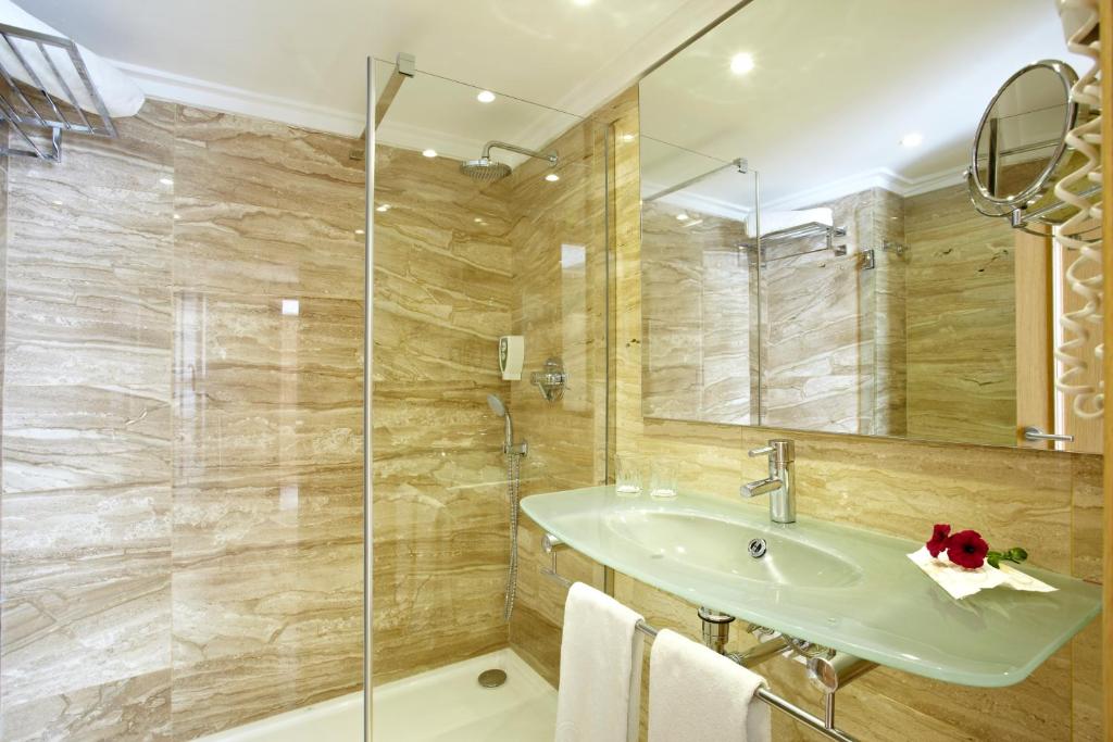 a bathroom with a sink and a shower at Grupotel Los Príncipes & Spa in Playa de Muro