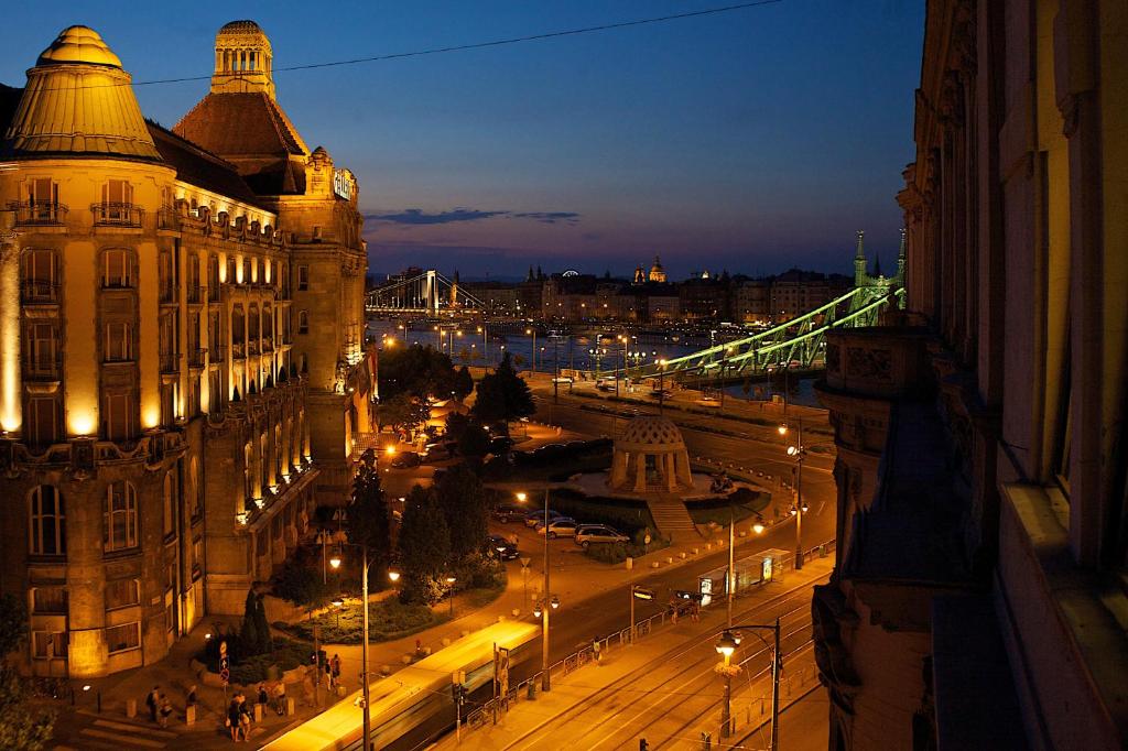 a view of a city at night with a bridge at Five Season's Apartment in Budapest