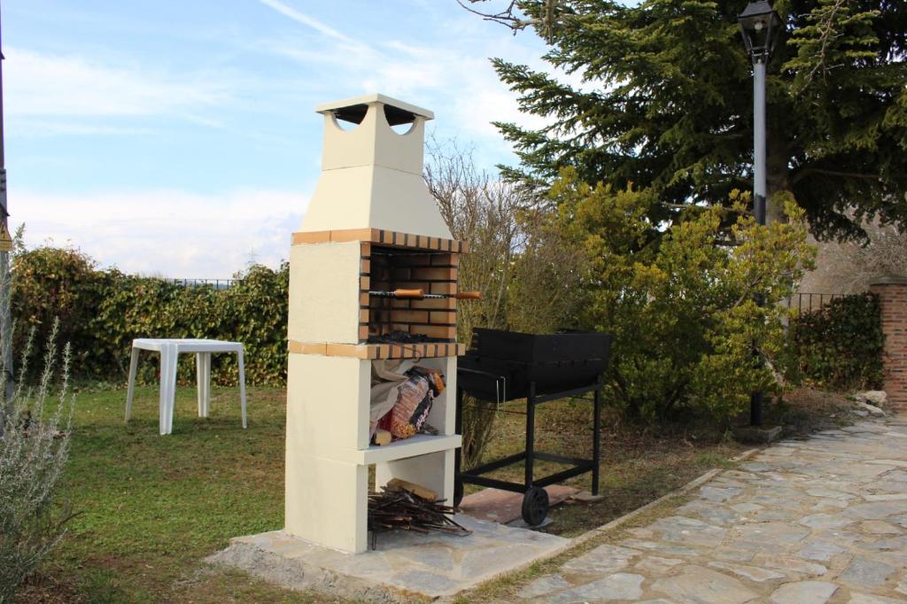 un horno de ladrillo con una parrilla en un patio en La Cuarta en Herrera de Pisuerga