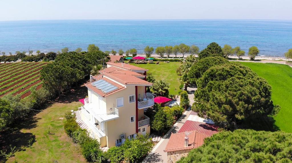 an aerial view of a house with the ocean in the background at Irida Beach Resort Suites in Kyparissia