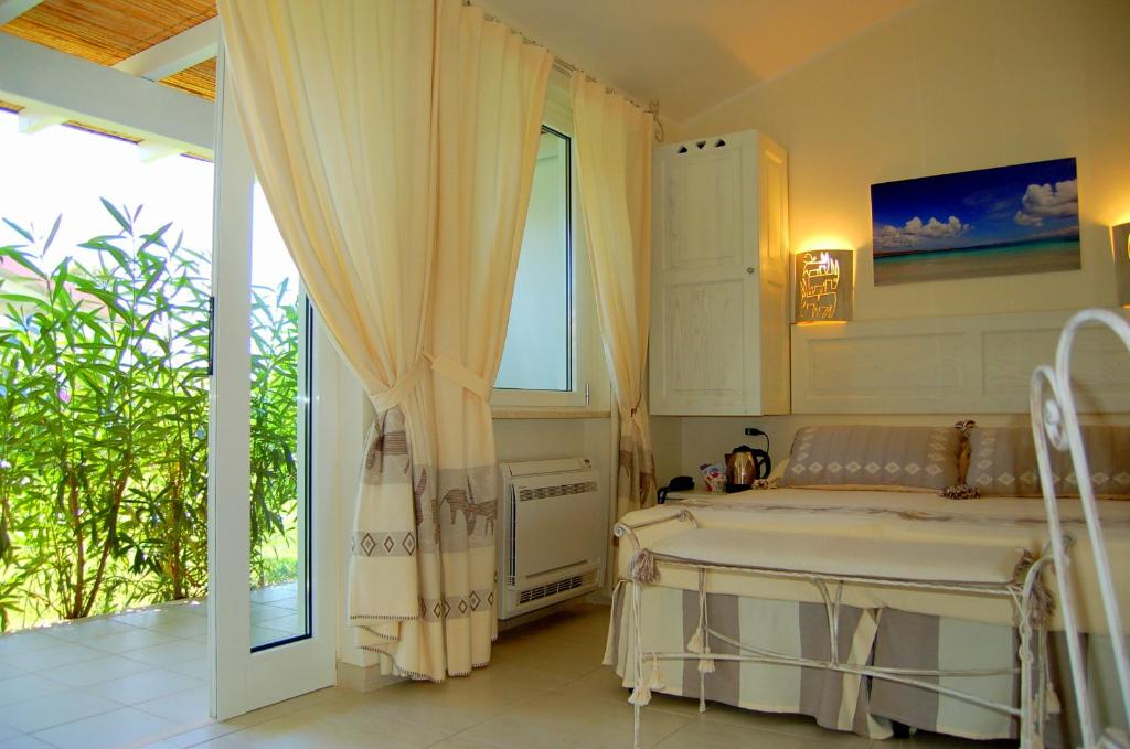 Postel nebo postele na pokoji v ubytování Hotel Budoni Beach