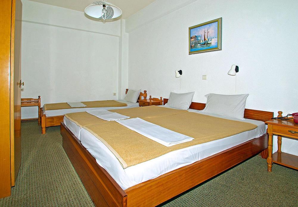 Postel nebo postele na pokoji v ubytování Hotel Helios